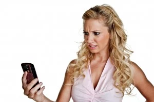 Confused Girl With Cellphone - Credit- iStockphoto - 133941670