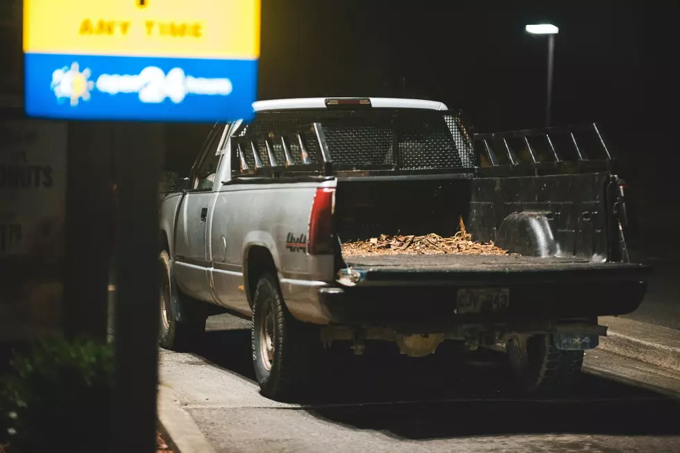 Truck with tailgate open and wood chips everywhere.